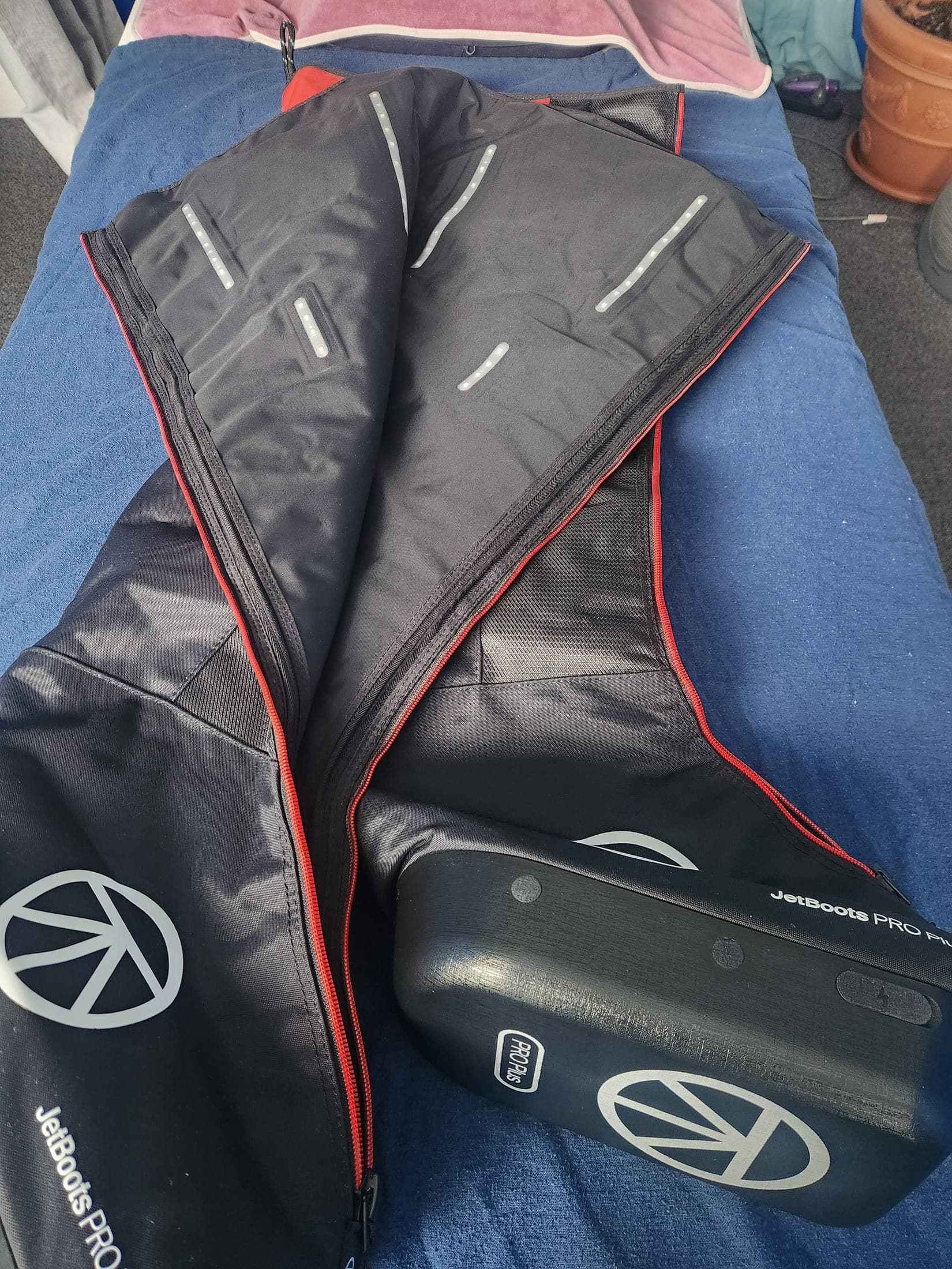 Close-up of the unzipped JetBoots Pro Plus compression boots showing the internal air-chamber panels